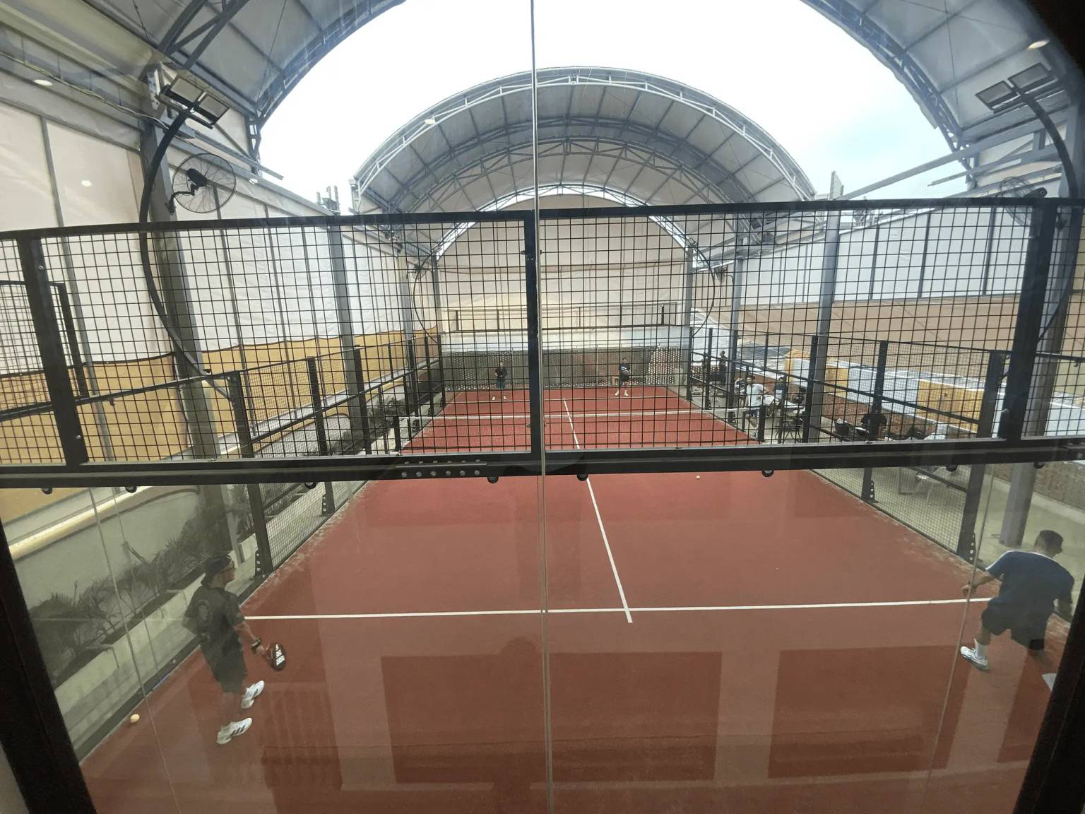 VIP Club Kemang panoramic glass padel court under sunlight